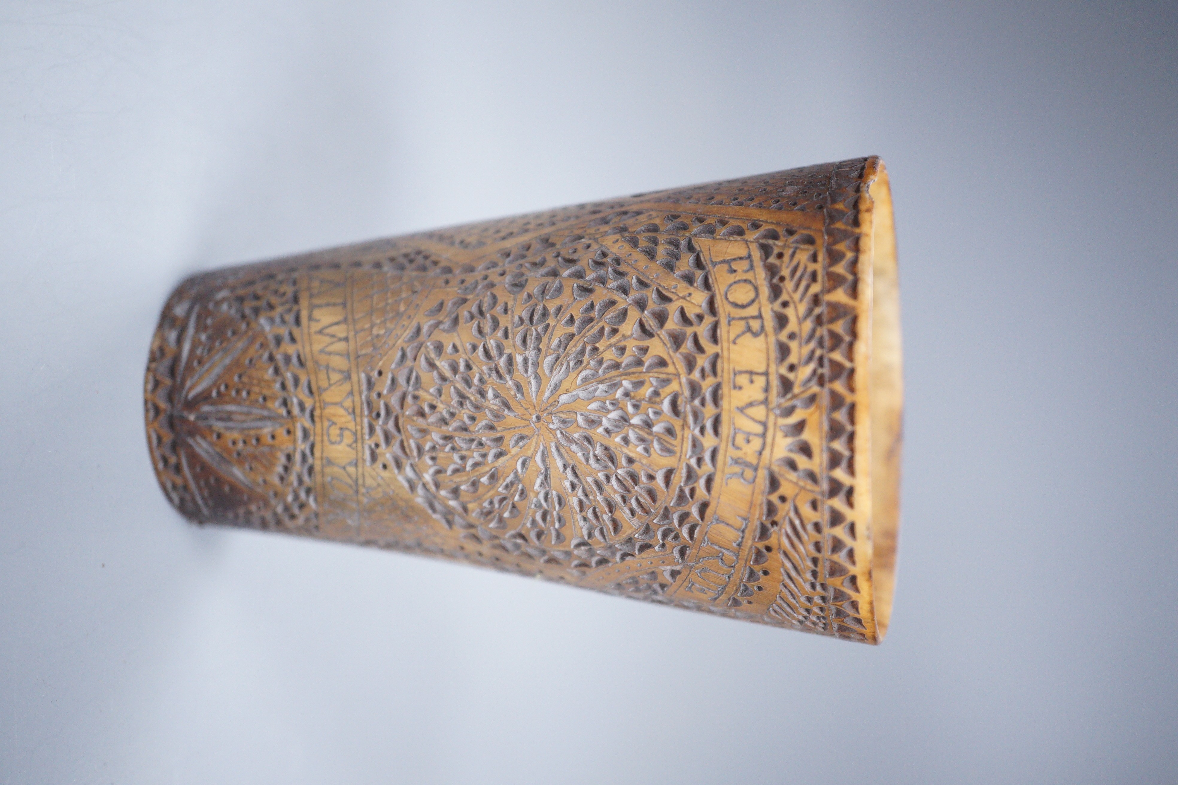 A 19th century carved horn beaker, titled ‘Ship Peru’, dated ‘Feb 12th 1840’, initialled ‘W.M’, the reverse carved ‘FOREVER TRUE ALWAYS YOURS’, height 10cm